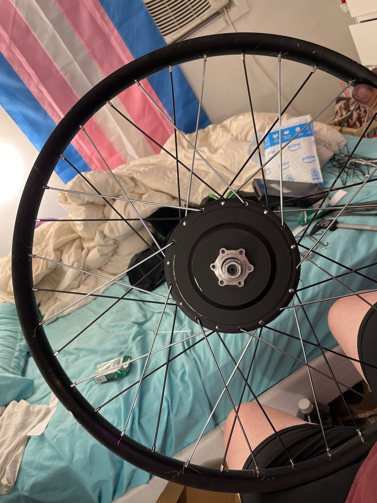 A fully re-laced and evenly tensioned 2 cross hub motor wheel